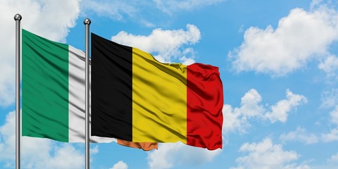 Ireland and Belgium flag waving in the wind against white cloudy blue sky together. Diplomacy concept, international relations.