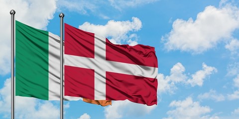Ireland and Denmark flag waving in the wind against white cloudy blue sky together. Diplomacy concept, international relations.