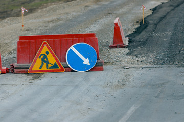 Signs on the road meaning repair and detour..Repair of the roadway.