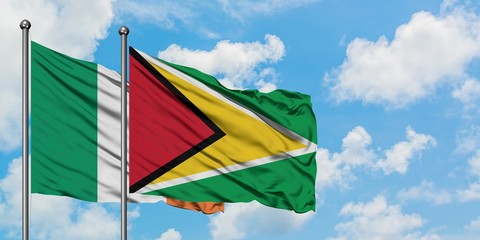 Ireland and Guyana flag waving in the wind against white cloudy blue sky together. Diplomacy concept, international relations.