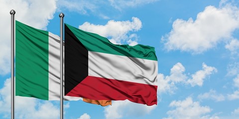 Ireland and Kuwait flag waving in the wind against white cloudy blue sky together. Diplomacy concept, international relations.