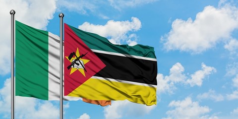 Ireland and Mozambique flag waving in the wind against white cloudy blue sky together. Diplomacy concept, international relations.