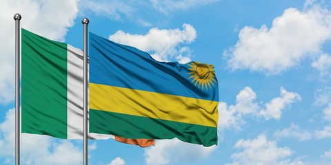 Ireland and Rwanda flag waving in the wind against white cloudy blue sky together. Diplomacy concept, international relations.