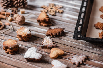 Christmas traditions. Freshly baked Christmas festive homemade cookies on a wooden table. Close-up.