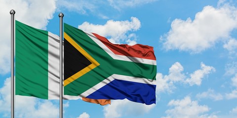 Ireland and South Africa flag waving in the wind against white cloudy blue sky together. Diplomacy concept, international relations.