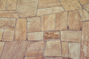 Texture of the old beige floor tiles of irregular shape