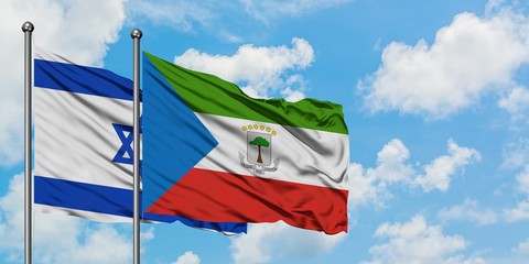 Israel and Equatorial Guinea flag waving in the wind against white cloudy blue sky together. Diplomacy concept, international relations.