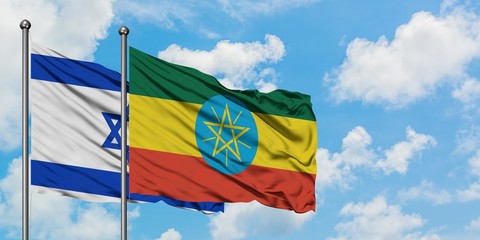 Israel and Ethiopia flag waving in the wind against white cloudy blue sky together. Diplomacy concept, international relations.