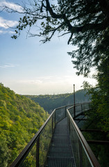 Obraz premium long suspension metal bridge in canyon in Georgia
