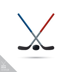 Ice hockey sticks and puck smooth vector icon. Sports equipment symbol.