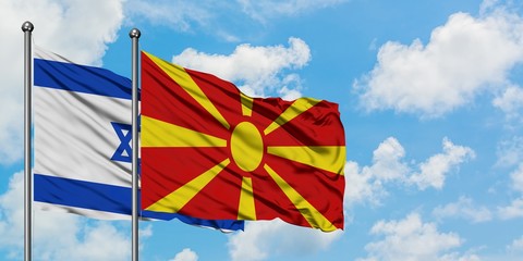 Israel and Macedonia flag waving in the wind against white cloudy blue sky together. Diplomacy concept, international relations.