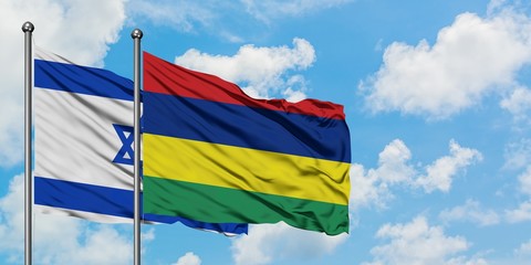 Israel and Mauritius flag waving in the wind against white cloudy blue sky together. Diplomacy concept, international relations.