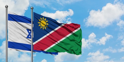 Israel and Namibia flag waving in the wind against white cloudy blue sky together. Diplomacy concept, international relations.
