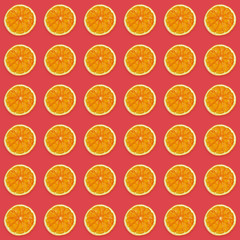 Seamless pattern of handmade dried orange slices on trendy pink background.