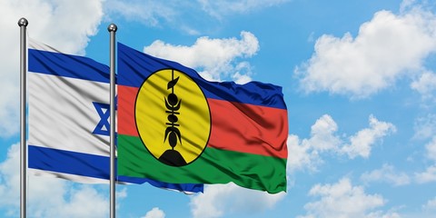 Israel and New Caledonia flag waving in the wind against white cloudy blue sky together. Diplomacy concept, international relations.