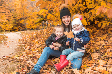 Fototapeta premium A portrait of a young family in the autumn park
