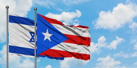 Israel and Puerto Rico flag waving in the wind against white cloudy blue sky together. Diplomacy concept, international relations.