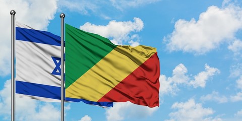 Israel and Republic Of The Congo flag waving in the wind against white cloudy blue sky together. Diplomacy concept, international relations.