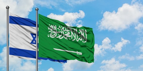 Israel and Saudi Arabia flag waving in the wind against white cloudy blue sky together. Diplomacy concept, international relations.