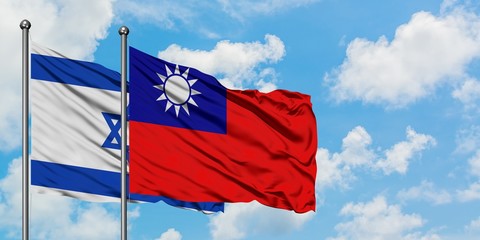 Israel and Taiwan flag waving in the wind against white cloudy blue sky together. Diplomacy concept, international relations.