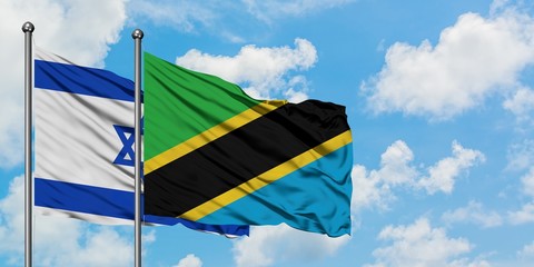 Israel and Tanzania flag waving in the wind against white cloudy blue sky together. Diplomacy concept, international relations.