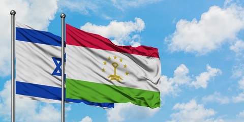 Israel and Tajikistan flag waving in the wind against white cloudy blue sky together. Diplomacy concept, international relations.