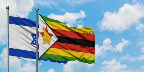 Israel and Zimbabwe flag waving in the wind against white cloudy blue sky together. Diplomacy concept, international relations.