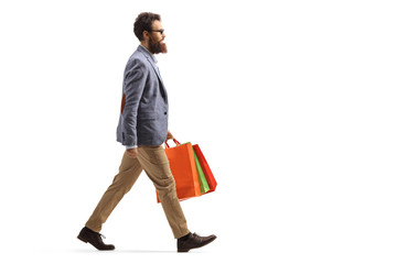 Bearded man walking and carrying shopping bags
