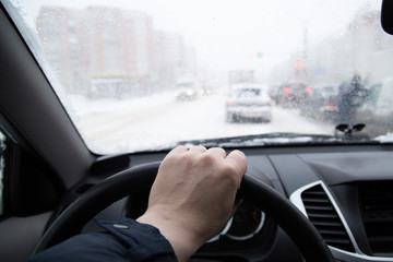 Snowfall.Driving in winter on ice under difficult conditions.