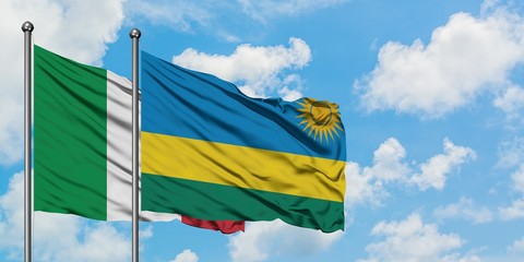 Italy and Rwanda flag waving in the wind against white cloudy blue sky together. Diplomacy concept, international relations.