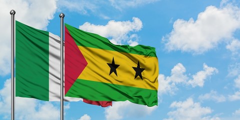 Italy and Sao Tome And Principe flag waving in the wind against white cloudy blue sky together. Diplomacy concept, international relations.