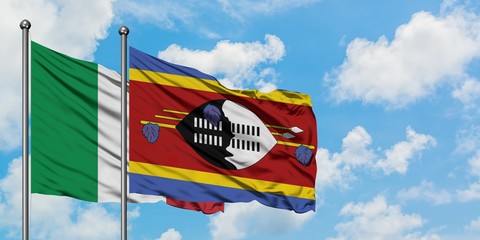 Italy and Swaziland flag waving in the wind against white cloudy blue sky together. Diplomacy concept, international relations.