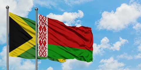 Jamaica and Belarus flag waving in the wind against white cloudy blue sky together. Diplomacy concept, international relations.