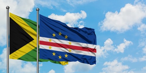Jamaica and Cape Verde flag waving in the wind against white cloudy blue sky together. Diplomacy concept, international relations.