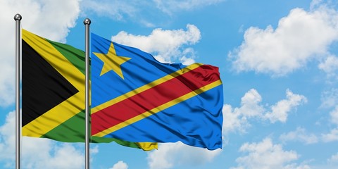 Jamaica and Congo flag waving in the wind against white cloudy blue sky together. Diplomacy concept, international relations.