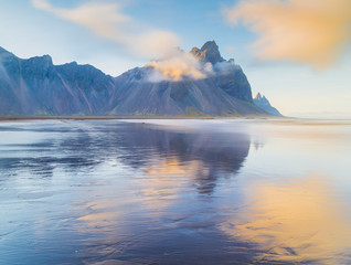 Reflection of Vestrahorn (Batman) mountain in the water at high tide. Colorfur morning scene of Stokksnes headland. Southeastern Iceland, Europe. Visit Iceland. Beauty world.