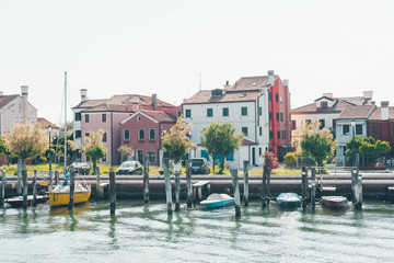 Fototapeta na wymiar Venice landmark, Burano island canal, colorful houses and small fishing boats, Italy.