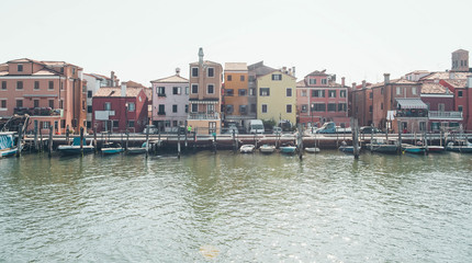 Fototapeta premium Venice landmark, Burano island canal, colorful houses and small fishing boats, Italy.