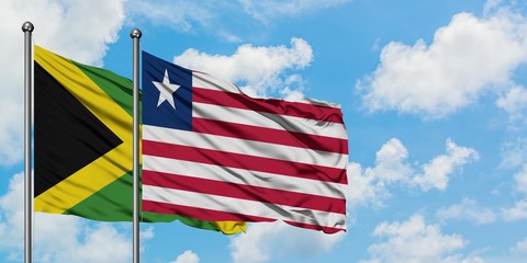 Jamaica and Liberia flag waving in the wind against white cloudy blue sky together. Diplomacy concept, international relations.