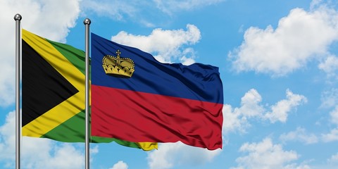 Jamaica and Liechtenstein flag waving in the wind against white cloudy blue sky together. Diplomacy concept, international relations.