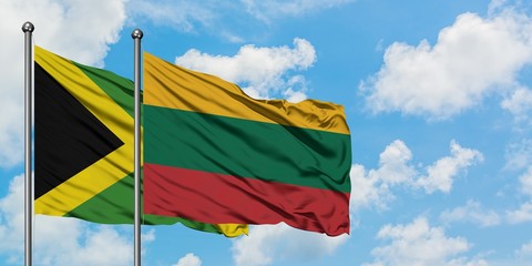 Jamaica and Lithuania flag waving in the wind against white cloudy blue sky together. Diplomacy concept, international relations.