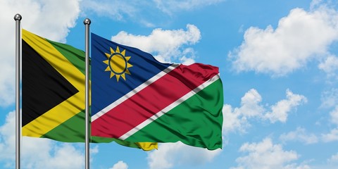 Jamaica and Namibia flag waving in the wind against white cloudy blue sky together. Diplomacy concept, international relations.