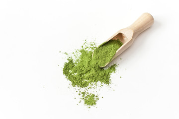 Wooden spoon with powdered matcha green tea in bowl isolated on white background.