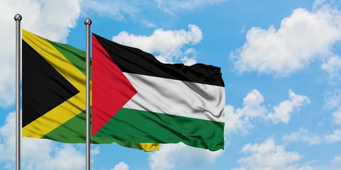 Jamaica and Palestine flag waving in the wind against white cloudy blue sky together. Diplomacy concept, international relations.