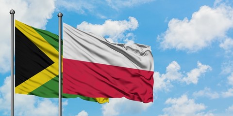 Jamaica and Poland flag waving in the wind against white cloudy blue sky together. Diplomacy concept, international relations.