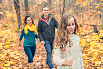 A portrait of a young family in the autumn park