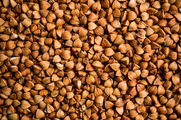 The texture of dry buckwheat. Background image of buckwheat porridge. Maro's Photo