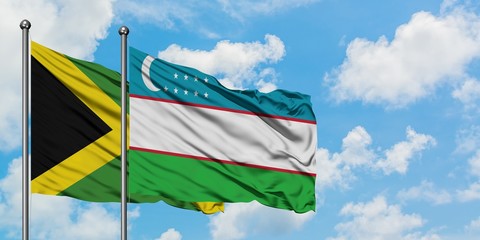 Jamaica and Uzbekistan flag waving in the wind against white cloudy blue sky together. Diplomacy concept, international relations.