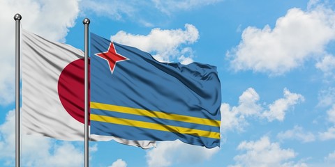 Japan and Aruba flag waving in the wind against white cloudy blue sky together. Diplomacy concept, international relations.