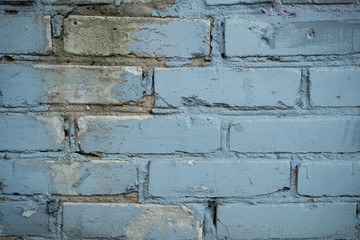 Texture of an old paint covered brick wall. Background image of an abandoned brick wall with painted over paint